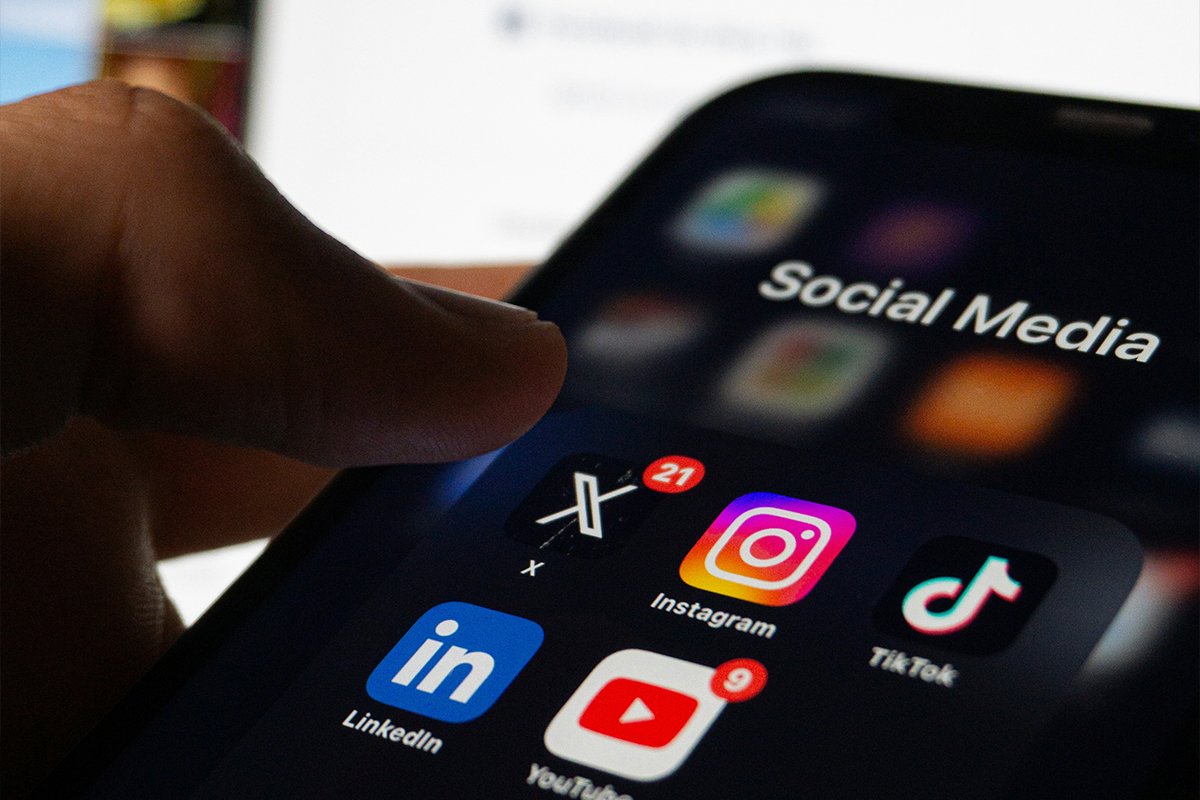 Close-up of a smartphone screen showing popular social media apps including X (Twitter), Instagram, TikTok, LinkedIn, and YouTube, symbolizing the importance of digital presence for business growth.